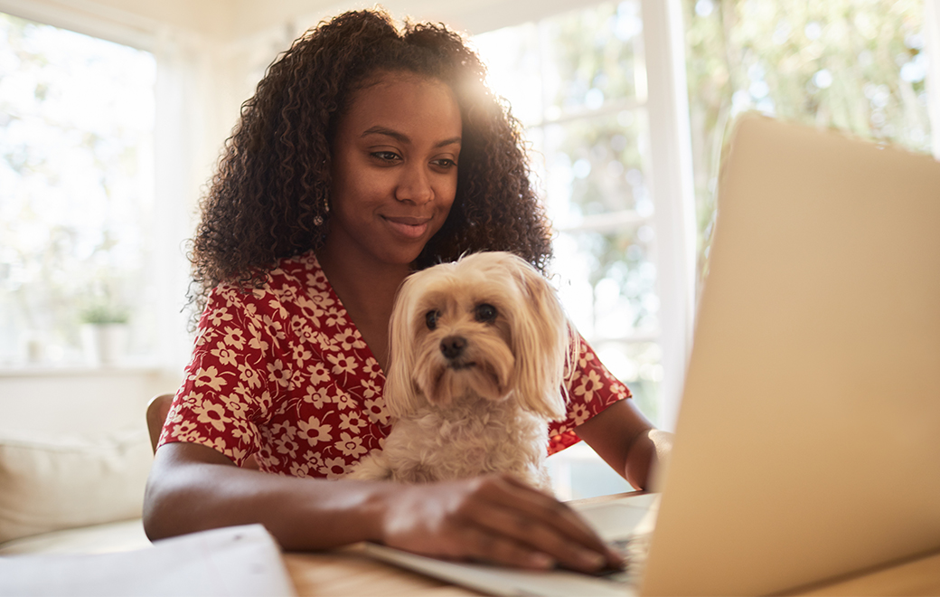 Woman with her dog on laptop
